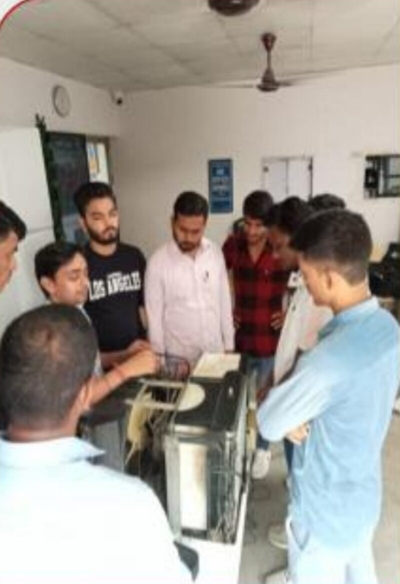 Trainer explaining split AC indoor unit components to students