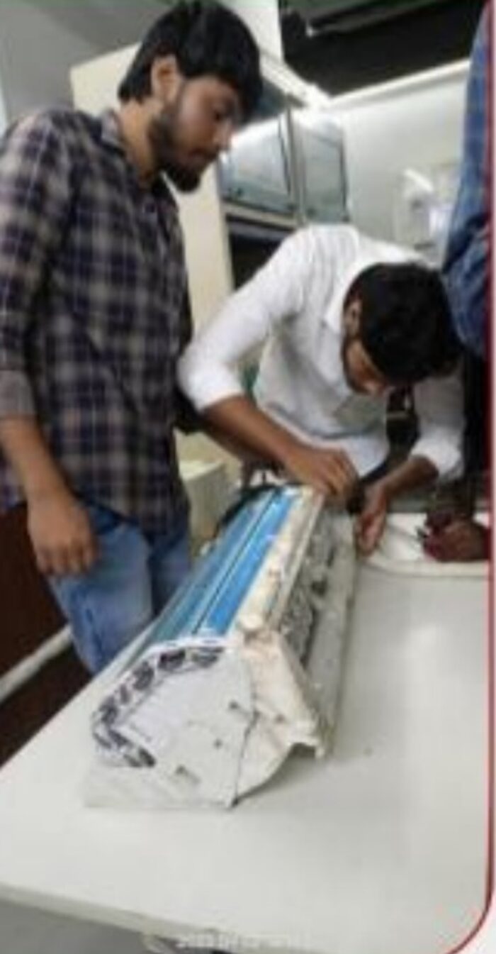Student performing indoor unit servicing practical
